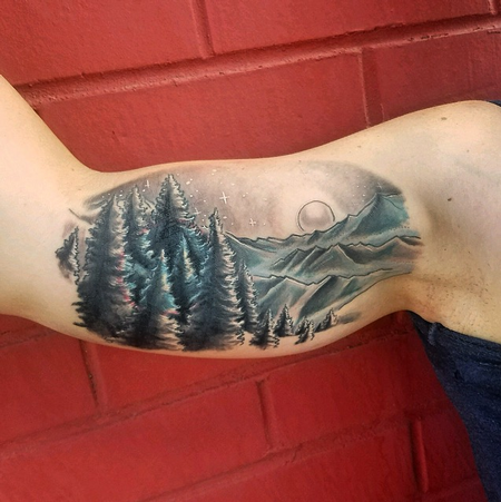 Cody Cook - black and grey mountain scene inside arm tattoo